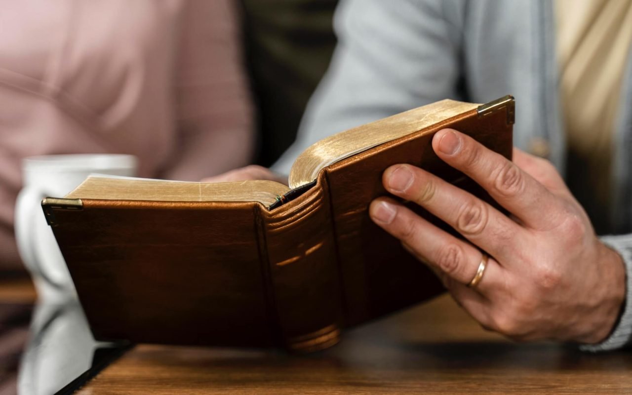people-kitchen-reading-from-bible