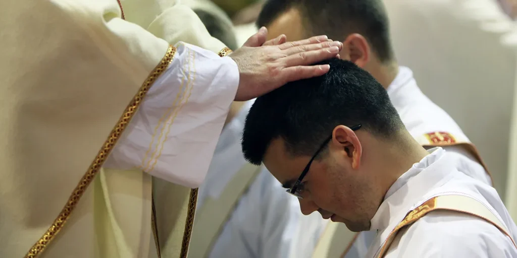 ordination-priest-hands-church